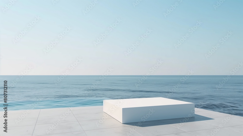 Minimalist white block on an oceanfront, clear blue sky.