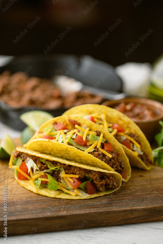 yellow hard shell tacos on cutting board yellow hard shell tacos on cutting board