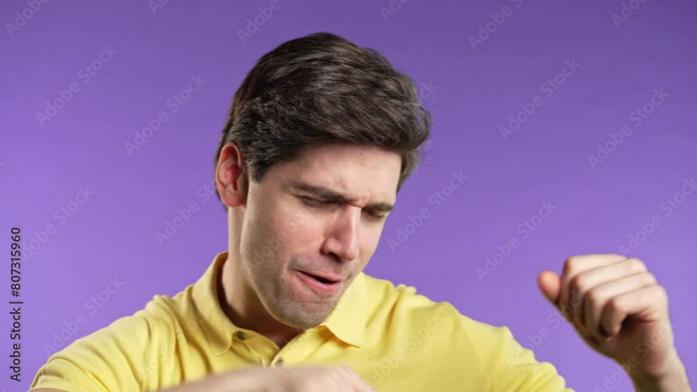Happy positive brunette man dancing on violet background.Funny guy, great day Happy positive brunette man dancing on violet background.Funny guy, great day