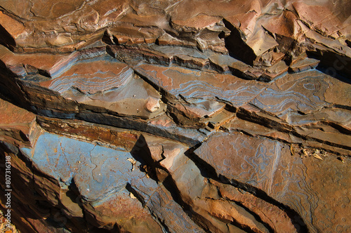 Blue patterns and structures on layers of banded ironstone formations in Karijini National park, in the Hamersley Range, Western Australia
