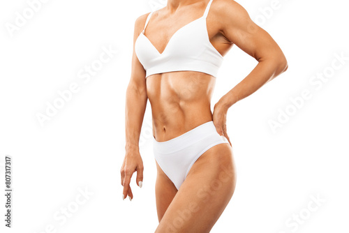A slender swarthy woman in a white underwear on a white background. Healthy lifestyle, sport and diet.