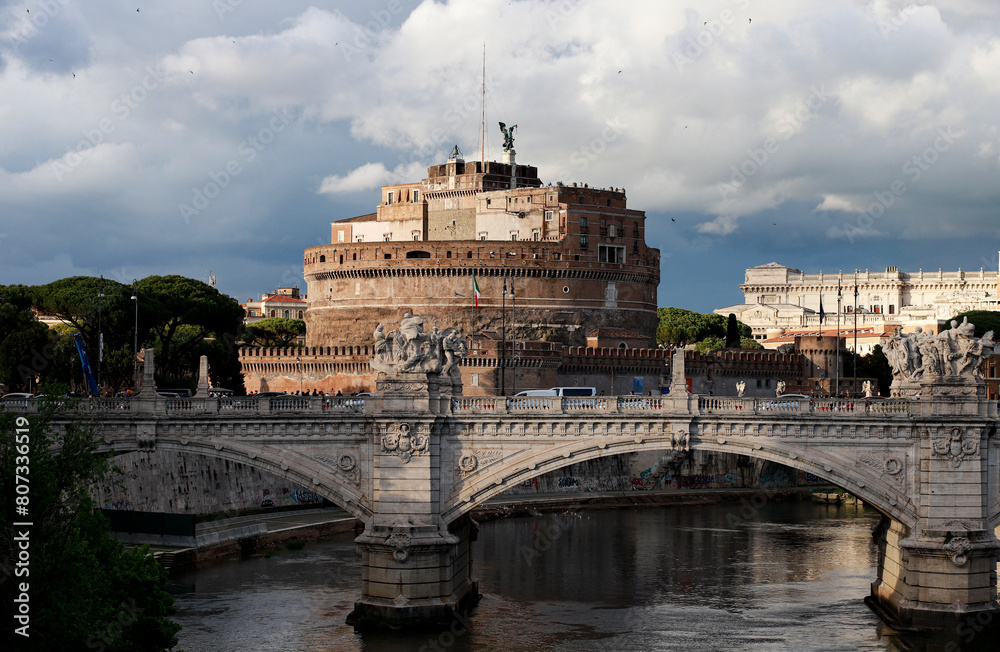 Ponte Vittorio Emanuele II in Rome, in the background the mass of Castel Sant'Angelo, sky full of clouds.