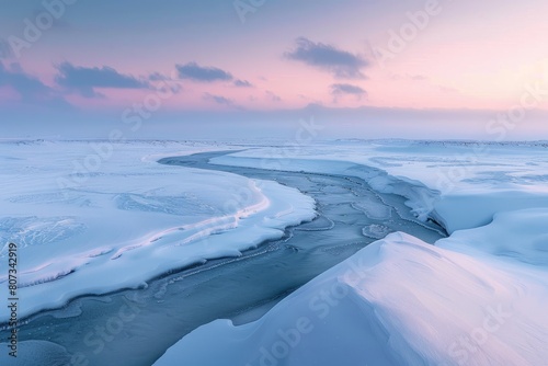 A panoramic view of a snow-covered landscape at dusk, featuring a winding river flowing through the serene winter scene