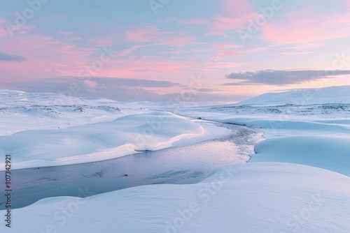 A panoramic view of a snow-covered landscape with a river winding its way through the serene winter scene at dusk