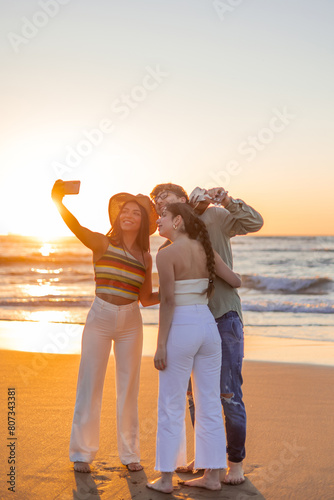 vertical Diverse Group of Friends Enjoying Sunset Beach Selfie with smartphone