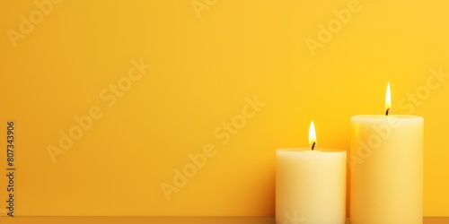 Yellow background with white thin wax candle with a small lit flame for funeral grief death dead sad emotion with copy space texture for display products