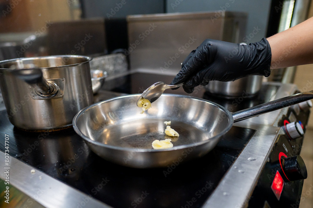 chef frying butter in pan at kitchen