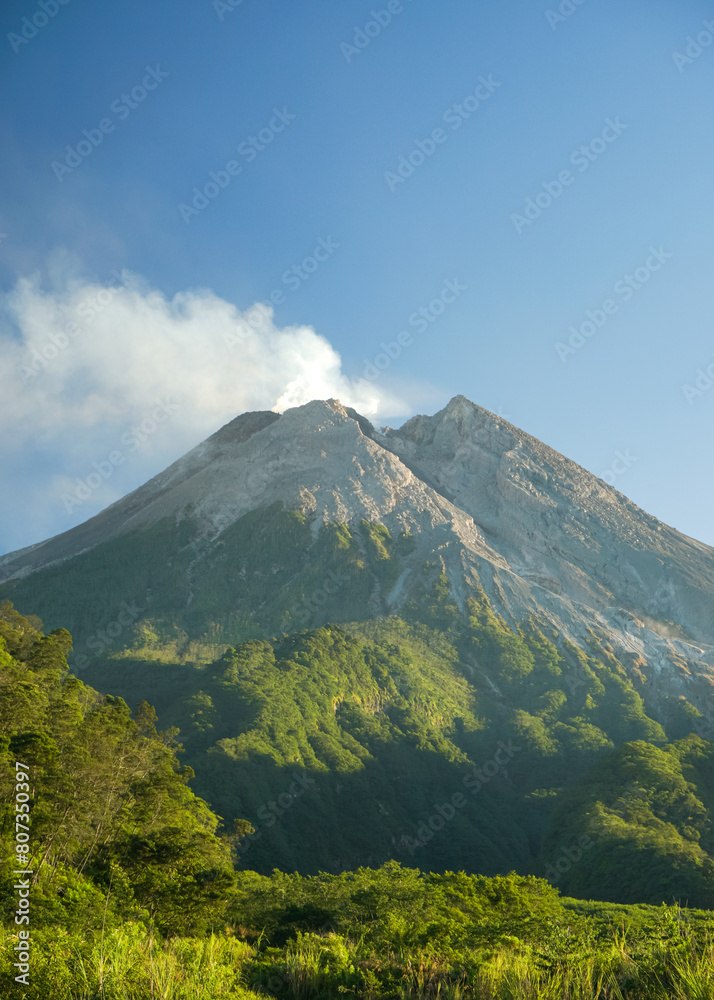 a portrait of merapi mountain in spring at yogyakarta, indonesia. with splendor and steam from the lava