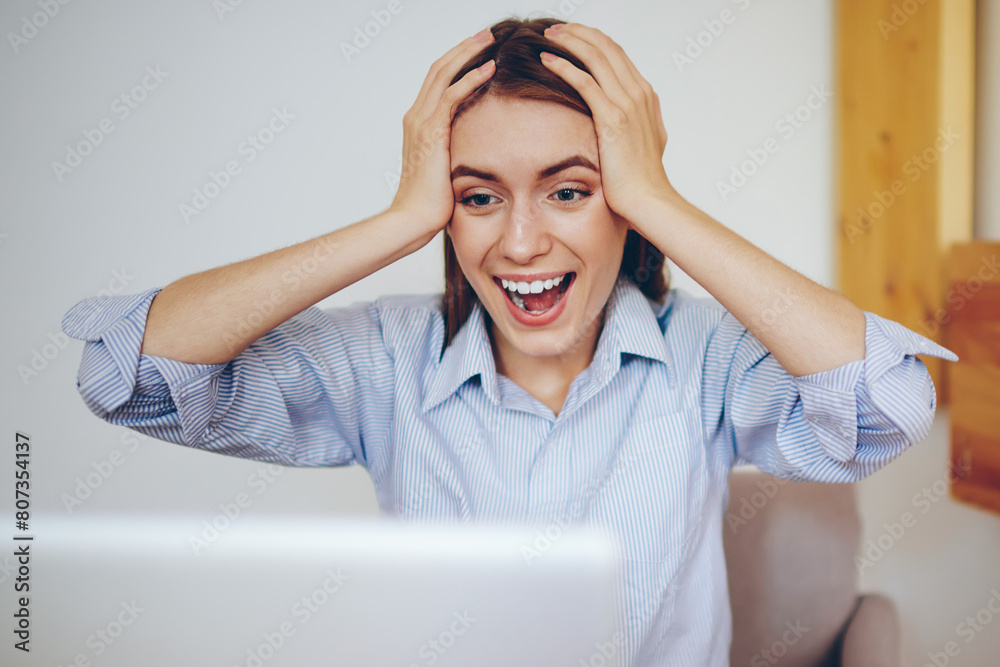 Happy hipster girl feeling excited from shopping online via laptop computer indoors, shocked attractive woman surprised by big discounts and special offer receiving in mail on modern netbook Happy hipster girl feeling excited from shopping online via laptop computer indoors, shocked attractive woman surprised by big discounts and special offer receiving in mail on modern netbook