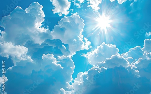 Vibrant blue sky with soft, fluffy clouds and radiant sunlight.