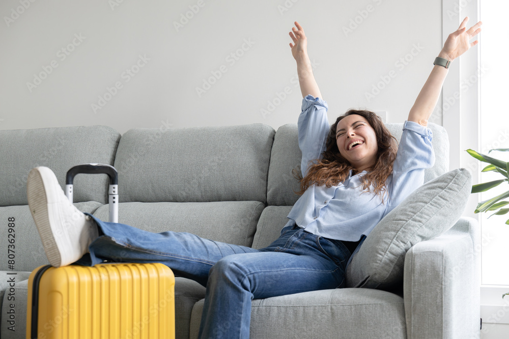 Woman posing happy ready to travel with suitcase Woman posing happy ready to travel with suitcase