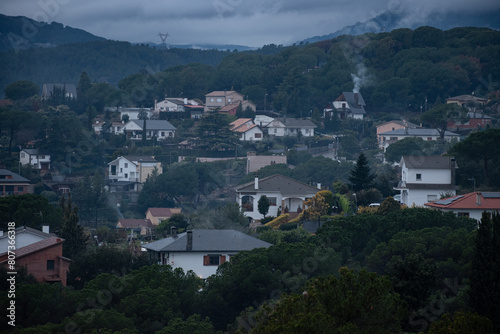 Close-up of houses in a housing estate after rain, with mist.