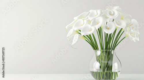 Bouquet of white calla flowers in a glass vase