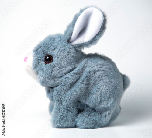 A white plush bunny on a grey background