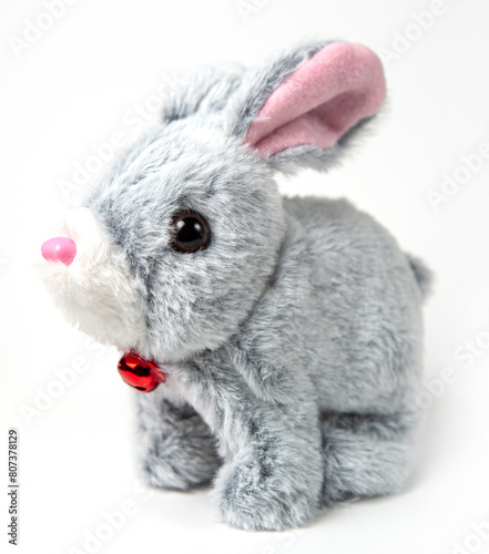 A white plush bunny on a grey background