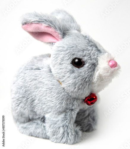 A white plush bunny on a grey background