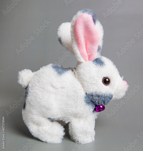 Soft fluffy rabbit toy with long ears, isolated on a white background