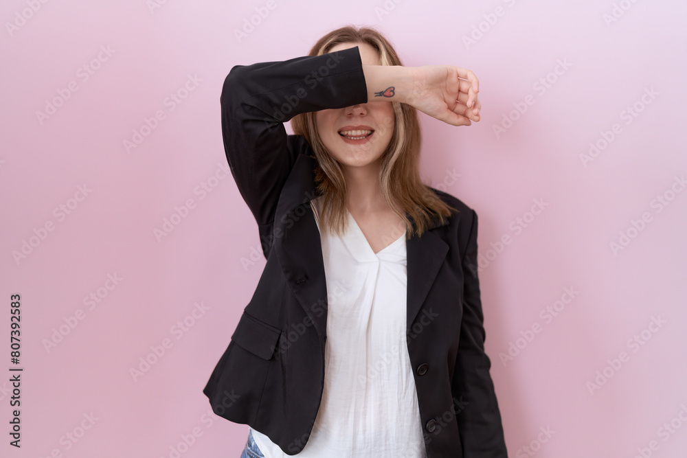 Young caucasian business woman wearing black jacket covering eyes with arm smiling cheerful and funny. blind concept. Young caucasian business woman wearing black jacket covering eyes with arm smiling cheerful and funny. blind concept.