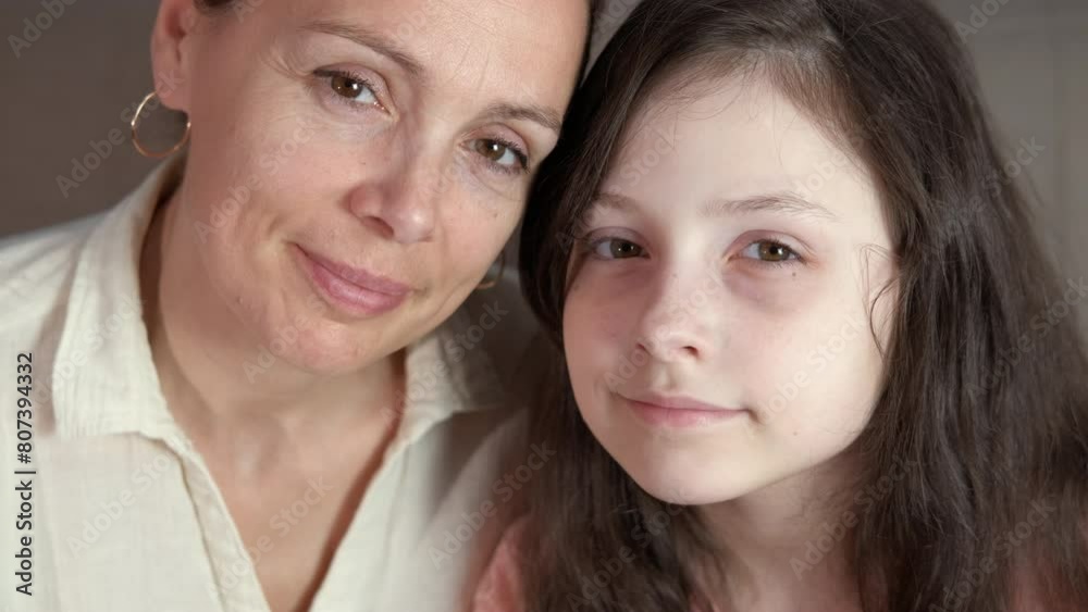 Feeling hugs together with mum inside. A teen girl feeling love for her mum and embrace her in the room. Feeling hugs together with mum inside. A teen girl feeling love for her mum and embrace her in the room.