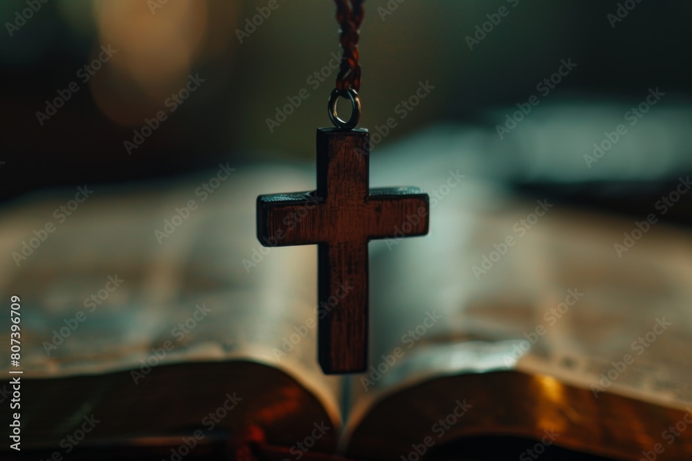 A wooden cross necklace hanging from the edge of an open Bible, with a blurred background and copy space on a black background Generative AI
