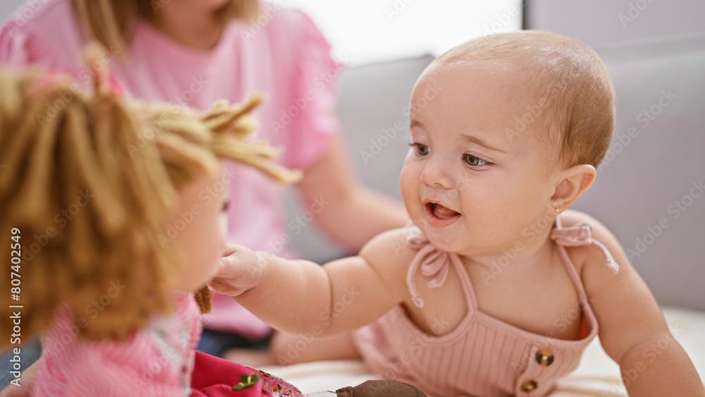 Cool mum and tiny tot, a casual indoor lifestyle of a mother and daughter's lovely playtime, sitting together on sofa playing with toys at home. Cool mum and tiny tot, a casual indoor lifestyle of a mother and daughter's lovely playtime, sitting together on sofa playing with toys at home.
