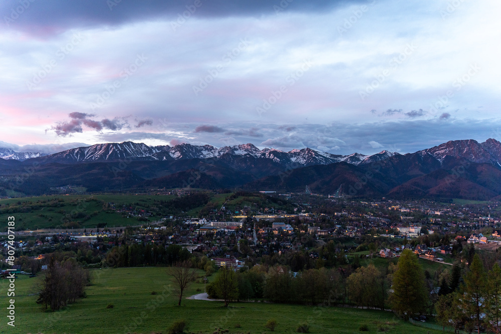 Fototapeta premium A town in the Zakopane Mountains before dawn. Poland. City lights.