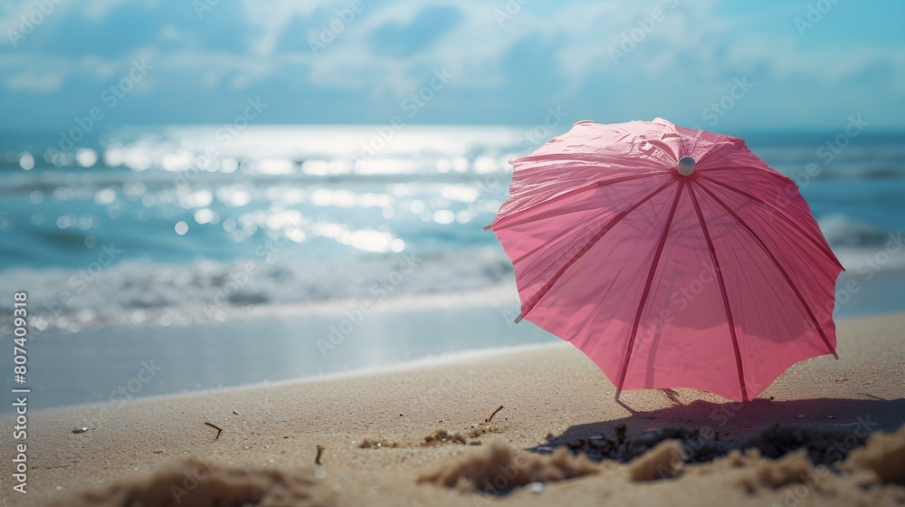 Close up of a pink Cocktail Umbrella at the Beach. Beautiful Summer Vacation Background