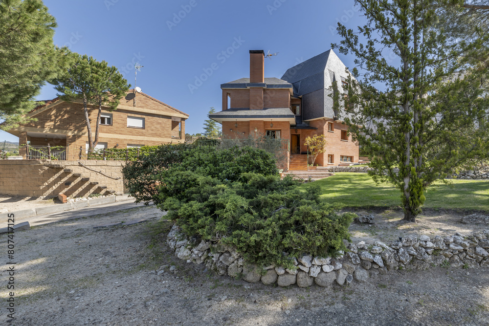 Estate with gardens and hedges with stony edges in an urbanization of single-family homes Estate with gardens and hedges with stony edges in an urbanization of single-family homes