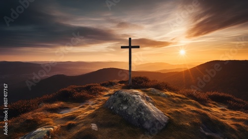 Silhouette of a cross on a hilltop at sunset