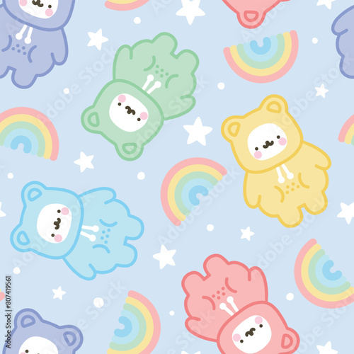 Cute hand drawn polar bear with kawaii stars and rainbow and dots blue background in a colorful adorable violet, pink , green, red, yellow warm pajama or hoodie, bedding desigh seamless pattern