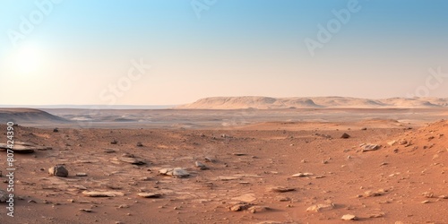 Vast desert landscape with rocky hills in the distance