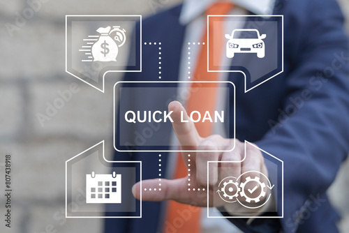 Business man working on virtual touch screen presses inscription: QUICK LOAN. Concept of quick and easy loan, fast money providence, business and finance services. Timely payment. Easy instant credit. photo