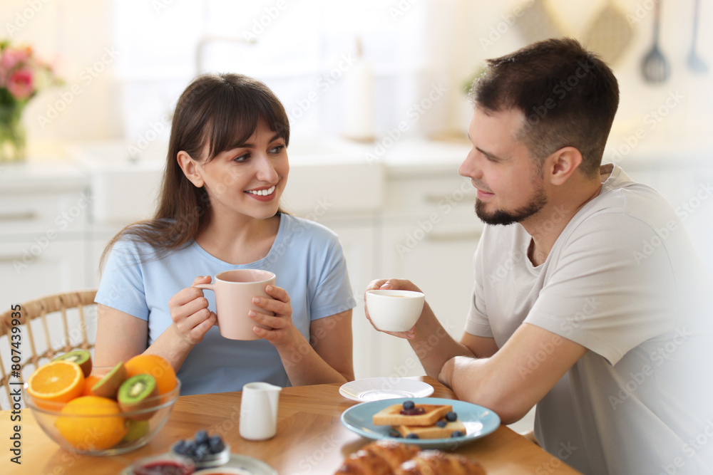 Happy couple having tasty breakfast at home Happy couple having tasty breakfast at home