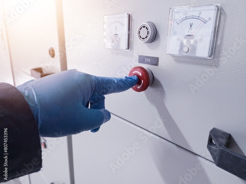 A hand engineer push the Emergency Push Botton on panel control when emergency condition.How to use emergency switch on panel control power plant.