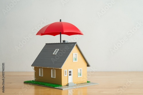 фотографія Red umbrella cover home model on wooden table with white background copy space