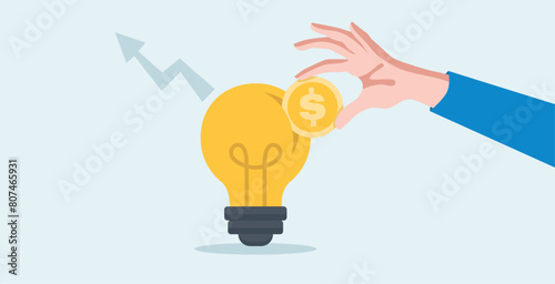 businessman inserting coins into growth graph light bulb. Invest in growth stocks