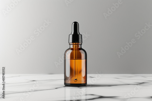 Glass bottle containing a serum for skincare displayed on a plain white surface. Presentation of a dropper attached to the container.