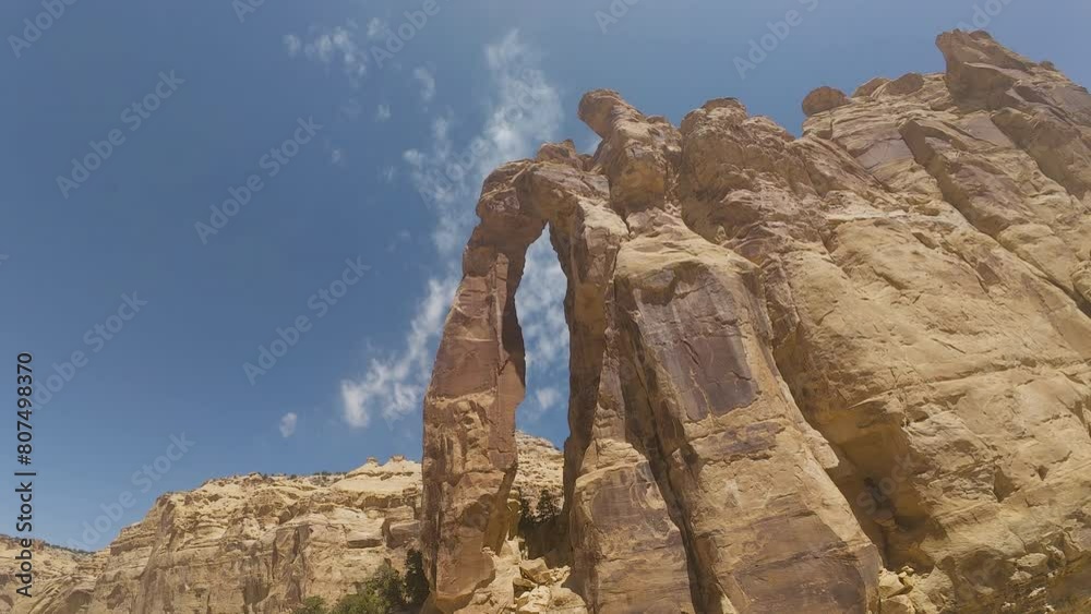 Potyo Rafael Rocks Aerial flying through Eagle Arch southern Utah. San Rafael Swell a ...