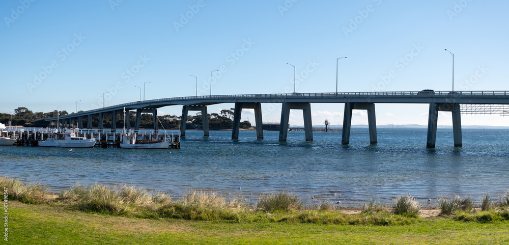 Panoramic coastal scenery of Phillip Island bridge and ships berth by the shore. at San Remo, VIC Australia.It is a cantilever bridge in Victoria that connects the Australian mainland. Panoramic coastal scenery of Phillip Island bridge and ships berth by the shore. at San Remo, VIC Australia.It is a cantilever bridge in Victoria that connects the Australian mainland.