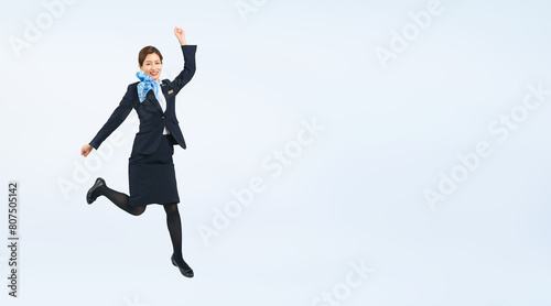 ジャンプする接客業の女性の全身写真（切り抜き背景透過PNGも販売しております。作成者リンクから「PNG」で検索してください）