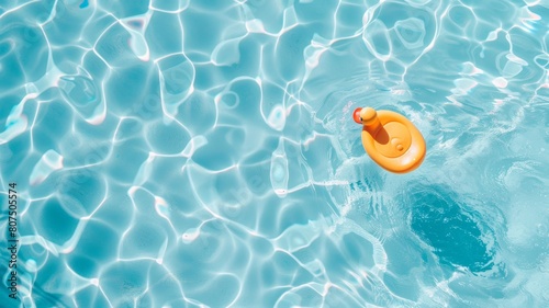 Top view of shadow on pool water surface with a rubber ducky floating in the water. Beautiful abstract background concept banner.