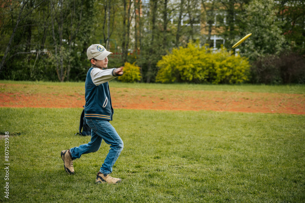 A boy throws disc golf. A young boy learns to throw a discus