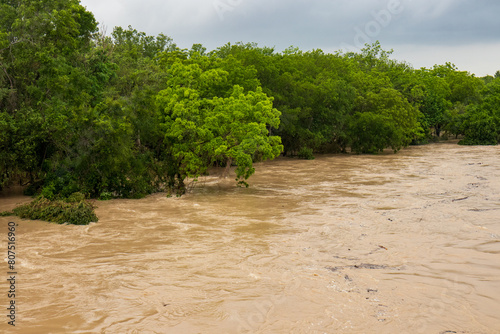The Lampasas River rushes and roars through the Texas Hill Country, leaving a trail of flood damage in its wake across the countryside. Spring rains a view from a bridge.