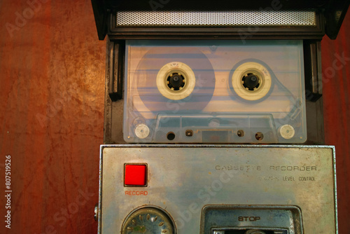 a cassette tape in a vintage tape recorder on wooden table old way listen to music