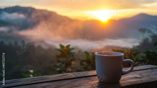 Morning cup of coffee with mountain background at sunrise