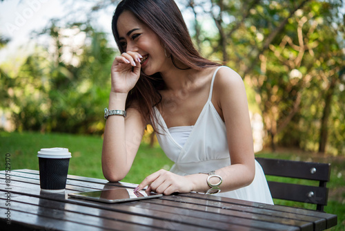 Woman drinking coffee hands holding hot disposable cup in green park. Happy Relax beautiful asian woman smiling face standing outdoors garden. Young women enjoy nature morning Freedom Lifestyle.