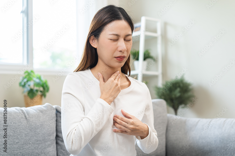 Acid reflux disease, suffer asian young woman have symptom gastroesophageal, esophageal, stomach ache and heartburn pain hand on chest from digestion problem after eat food, Healthcare medical concept