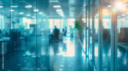 Blurred offices with people working behind glass walls © LU