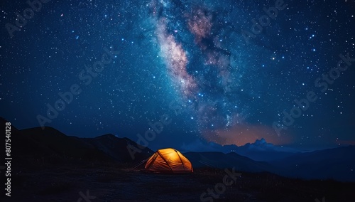 The silhouette of a tent beneath a vast expanse of stars.