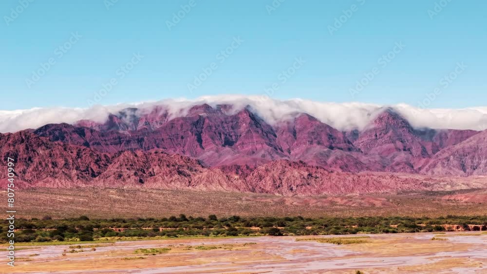 Drone hyperlapse captures the mountains of Cafayate, Salta, Argentina, as they are engulfed by swirling clouds. Drone hyperlapse captures the mountains of Cafayate, Salta, Argentina, as they are engulfed by swirling clouds.